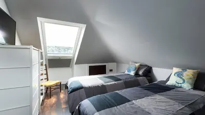 a bedroom with two beds and a window at HipNautic, Mevagissey, Sleeps 6 in Mevagissey