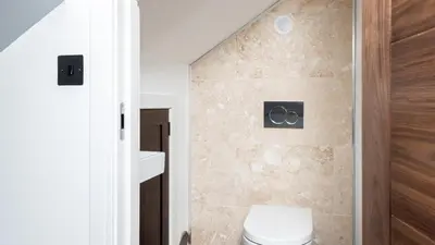 a bathroom with a toilet and a shower at HipNautic, Mevagissey, Sleeps 6 in Mevagissey