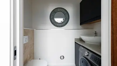 a bathroom with a sink and a washing machine at HipNautic, Mevagissey, Sleeps 6 in Mevagissey