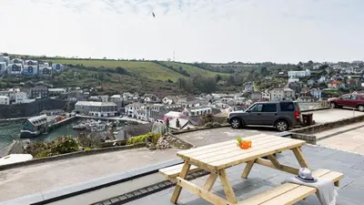 a wooden picnic table sitting on top of a roof at HipNautic, Mevagissey, Sleeps 6 in Mevagissey