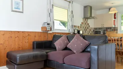 a leather couch with two pillows on it in a kitchen at Ta Mill Cottages & Lodges - Meadowview Chalet 3 in Launceston