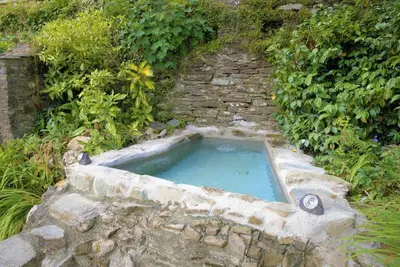 a small pool of water in a stone tub at Ta Mill Cottages & Lodges - Meadowview Chalet 3 in Launceston