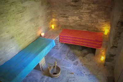 two benches sitting in a room with lights at Ta Mill Cottages & Lodges - Meadowview Chalet 3 in Launceston
