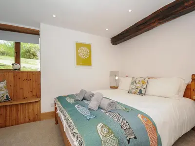 a bedroom with a bed with towels on it at Mill House in Lostwithiel