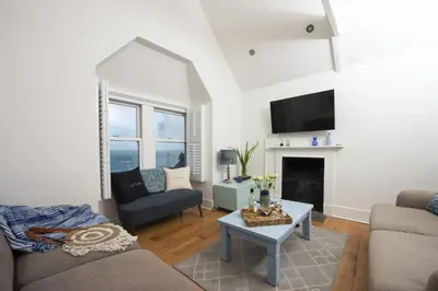 a living room with a couch and a fireplace at Mordros, St Ives in St Ives