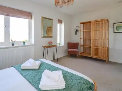 a bedroom with a bed with towels on it at The Waves in Newquay