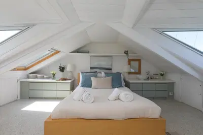 a bedroom with a bed with towels on it at Reflections in St Ives