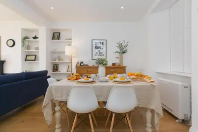 a dining room with a table with food on it at Reflections in St Ives