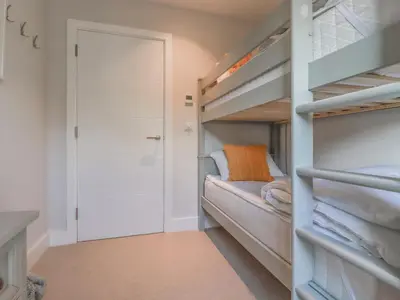 a bedroom with bunk beds and a closet at 7 Longshore in Newquay