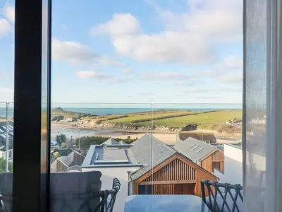 a view of the ocean from the balcony of a house at 7 Longshore in Newquay
