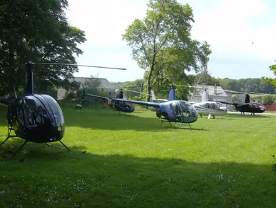 three helicopters parked in a field of grass at Trehellas House Hotel & Courthouse restaurant in Bodmin