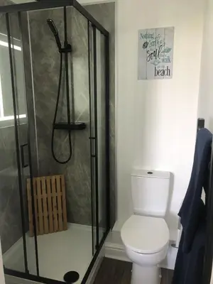 a bathroom with a shower and a toilet at 5 mins from the Eden Project Baybreeze Holiday Apartment, Sea Views, Super Kingsize Beds in St Austell