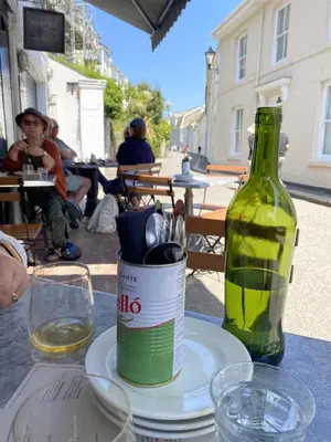 a bottle of wine sitting on top of a table at 5 mins from the Eden Project Baybreeze Holiday Apartment, Sea Views, Super Kingsize Beds in St Austell