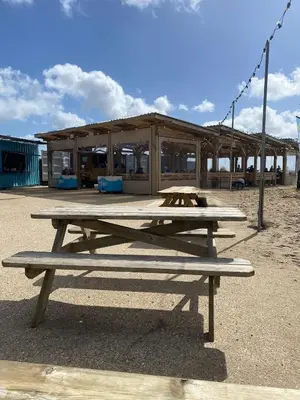 a picnic table sitting in front of a building at 5 mins from the Eden Project Baybreeze Holiday Apartment, Sea Views, Super Kingsize Beds in St Austell