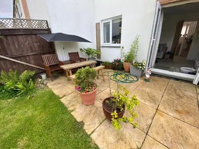 a patio with a table and benches and plants at Bodmin Rest 4 U in Bodmin