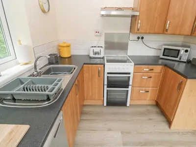 a kitchen with a sink and a stove at 11 Tremore in Liskeard