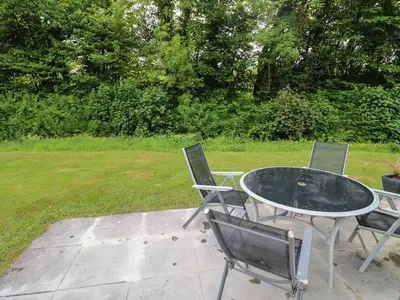 two chairs and a glass table in a yard at 11 Tremore in Liskeard
