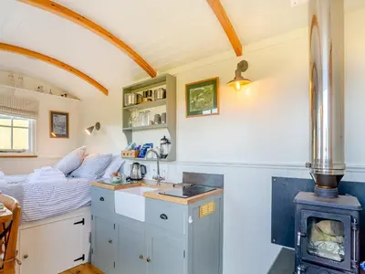 a small kitchen with a stove in a room at Shepherds Retreat in St Austell