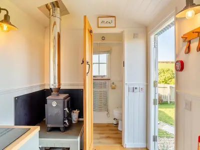 a kitchen with an old stove in a house at Shepherds Retreat in St Austell