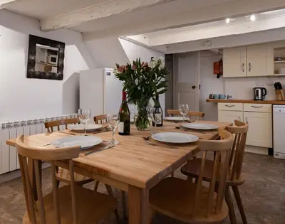 a wooden table in a kitchen with a dining room at St Samson in Port Isaac