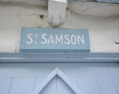 a blue sign that says s sansom on a building at St Samson in Port Isaac
