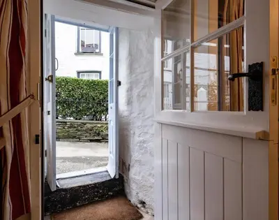 a door to a house with a window and a door at St Samson in Port Isaac