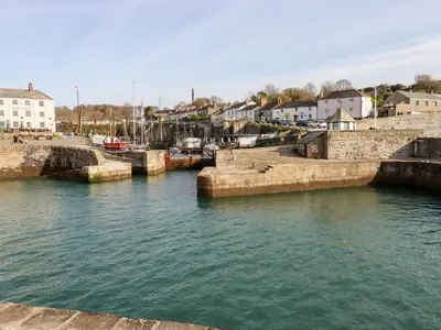 a group of boats docked in a body of water at Miners cottage in St Austell
