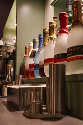 a group of bottles of alcohol on a shelf at Wayfarers Inn in Penzance