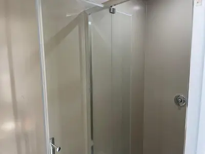 a shower with a glass door in a bathroom at Wayfarers Inn in Penzance