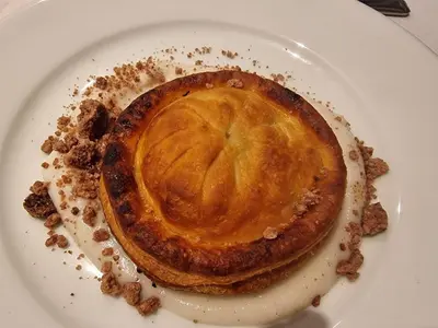 a pie on a white plate on a table at Wayfarers Inn in Penzance