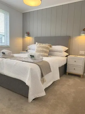 a bedroom with a large bed with white sheets and pillows at No14 Padstow in Padstow