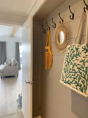 a hallway with a door and a mirror on a wall at No14 Padstow in Padstow