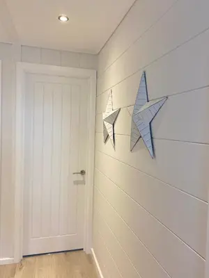a hallway with a door and two stars on the wall at No14 Padstow in Padstow