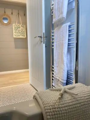 a bathroom with a sink and a shower with towels at No14 Padstow in Padstow