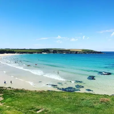 a beach with a group of people in the water at No14 Padstow in Padstow