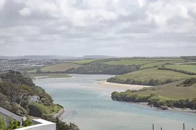 a view of a river with green fields and trees at Fistral View, Pentire - Parking, Sea view, free Wifi in Newquay