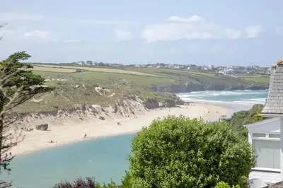 a view of a beach with people in the water at Fistral View, Pentire - Parking, Sea view, free Wifi in Newquay
