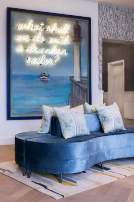 a blue couch in a room with a painting at Harbour Hotel Padstow in Padstow