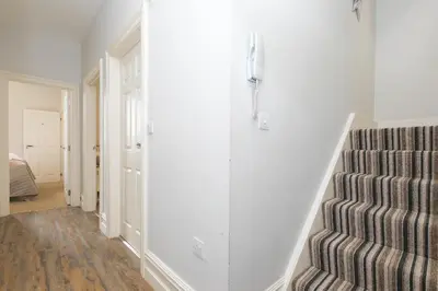 a hallway with a staircase and a stair case at Arghanti in St Ives