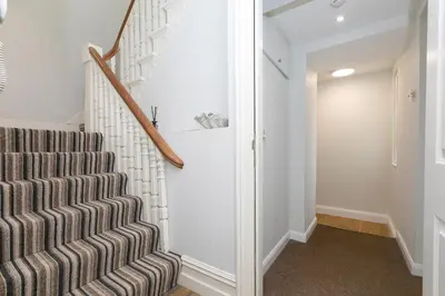 a staircase in a house with a stair case at Arghanti in St Ives
