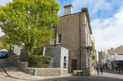 an old brick building on a city street at Arghanti in St Ives