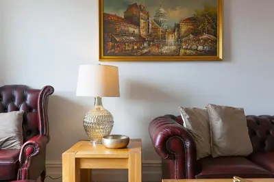 a living room with two chairs and a lamp on a table at Arghanti in St Ives
