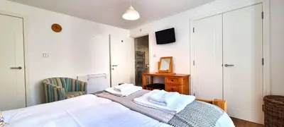 a bedroom with a bed with towels on it at No 1 Oceans in Perranporth