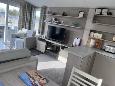 a living room with a couch and a tv at Porthcurno 4, Silverbow Country Park in Perranzabuloe