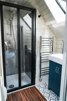 a bathroom with a glass shower and a sink at Mawgies in Saint Ervan
