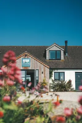 a house with a sign on the front of it at Mawgies in Saint Ervan