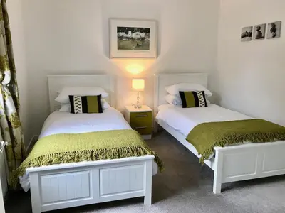 two beds sitting next to each other in a room at The Waterwheel Apartment, Charlestown in Charlestown
