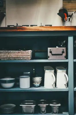 a shelf with bowls and utensils on it at Glamping at Macdonald's Farm in Saint Ervan