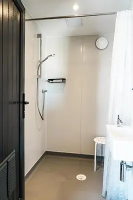 a bathroom with a shower and a sink at Glamping at Macdonald's Farm in Saint Ervan
