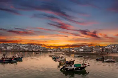 a group of boats in the water at sunset at Island Studio with on-site parking in St Ives